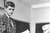 Thumbnail of Dr. Lester Tuttle handing a woman papers