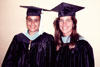 thumbnail of two students in gradutation gowns
